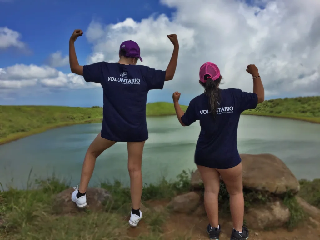 Two participants of the TEEN Camp in Galapagos, in front of a lagoon posing after the beach cleanup activity.