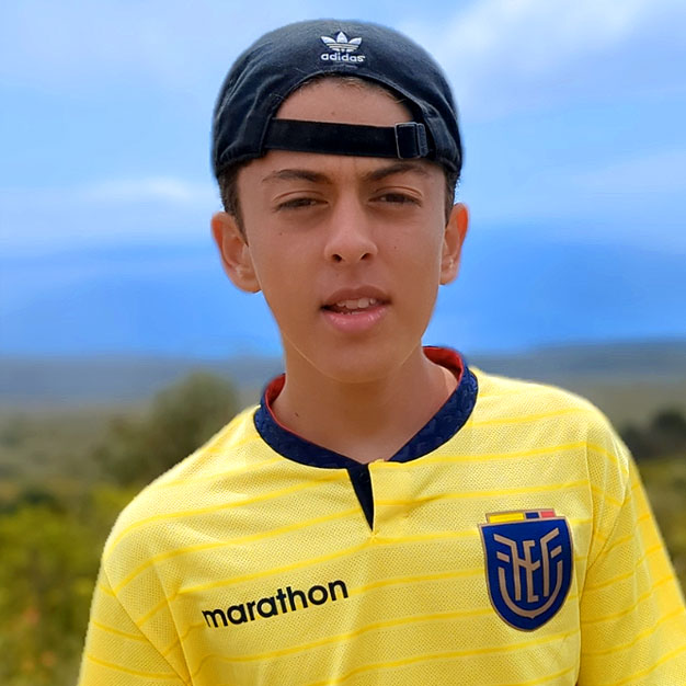 Portrait of José, a former Teen Camp participant, smiling and wearing the Ecuador soccer jersey. His testimonial highlights lessons an values for the life.