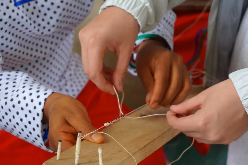 Teens learning ancestral technique during cultural camp in Ecuador