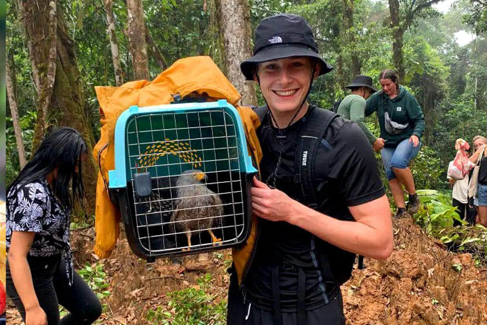 Teen participating in wild bird release during conservation camp in Ecuador