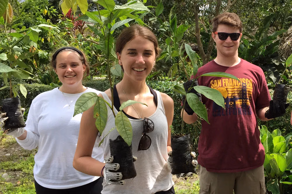 Teens participating in reforestation during youth camp in Ecuador