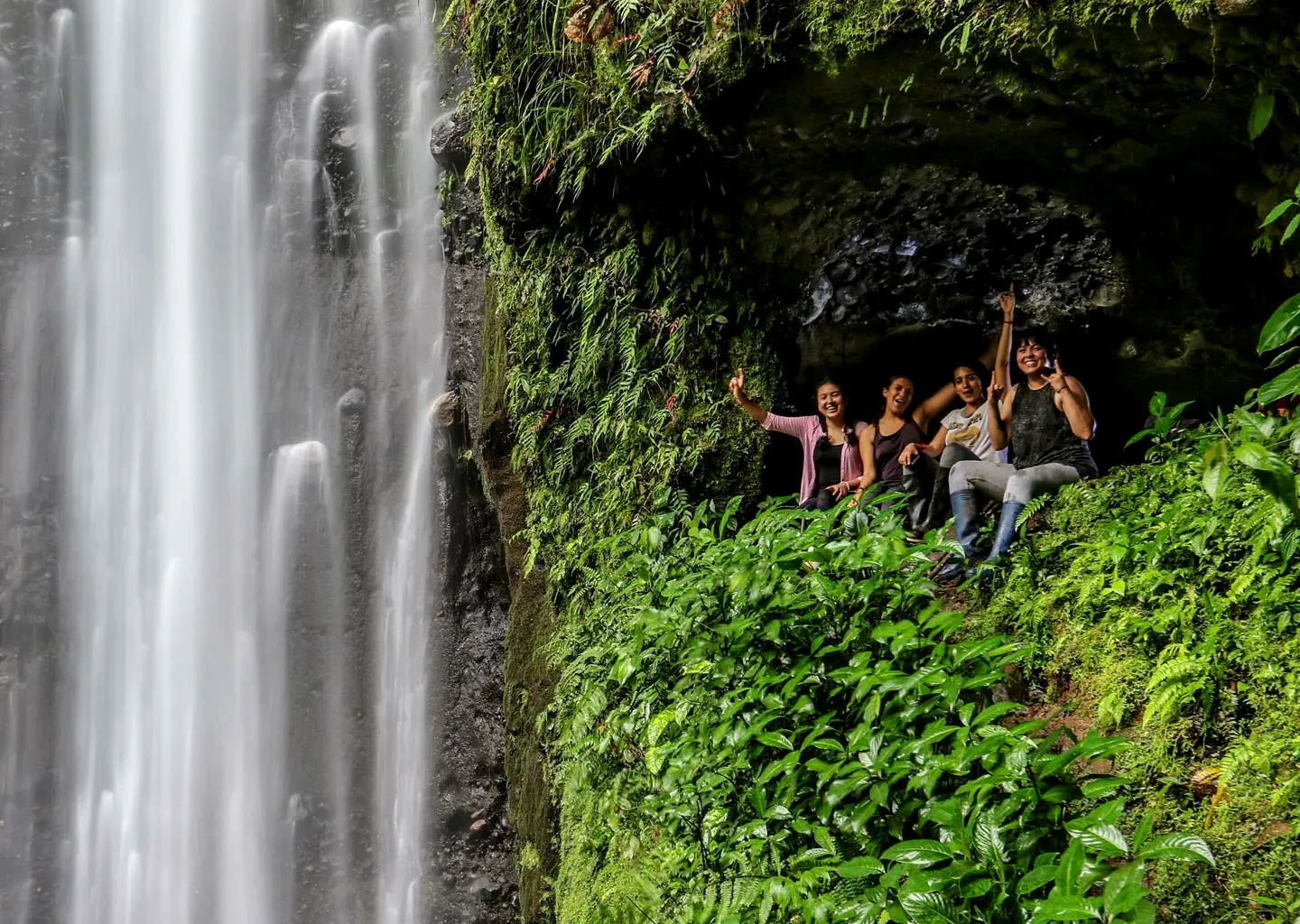 Teens enjoying waterfall adventure during Amazon camp in Ecuador