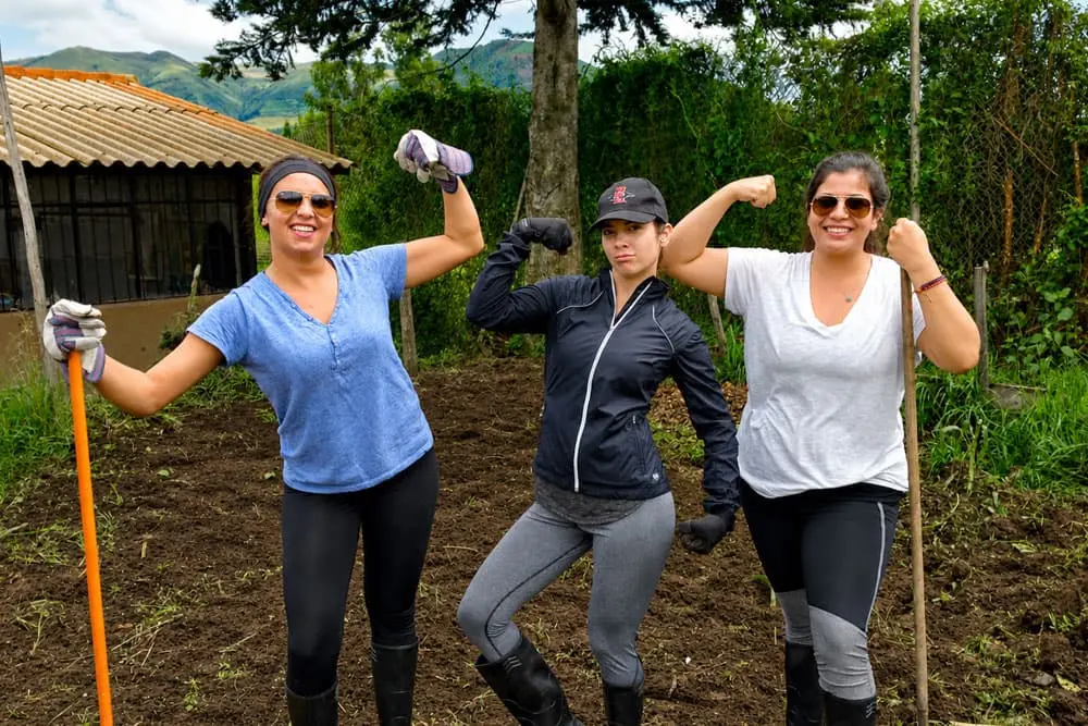 Teens planting crops during a sustainability and farming experience in the Ecuadorian Andes