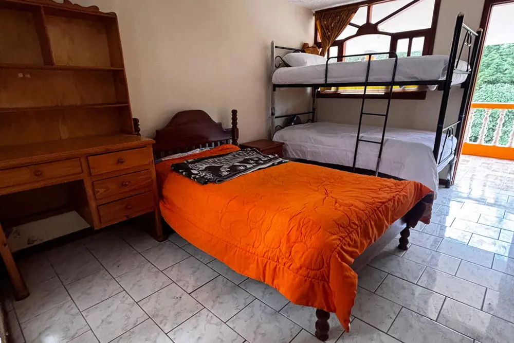 Shared bedroom accommodation for teen participants during an Andes leadership camp in Ecuador