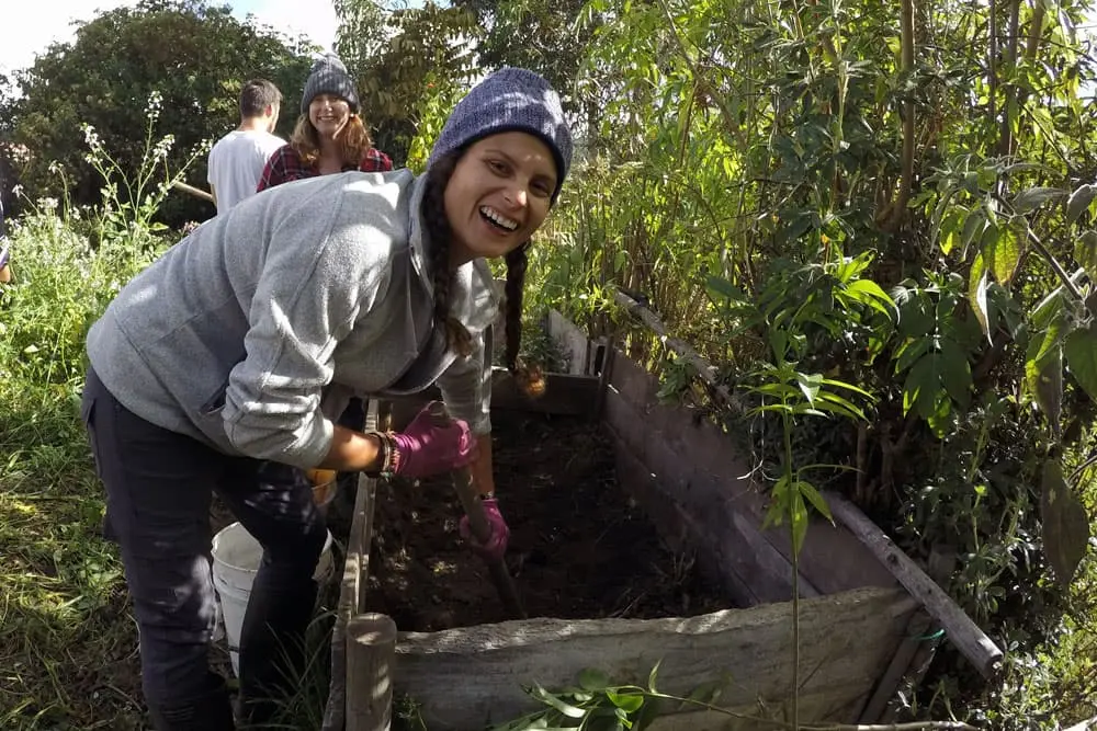 Teen participants building compost beds during a sustainability leadership program in Ecuador