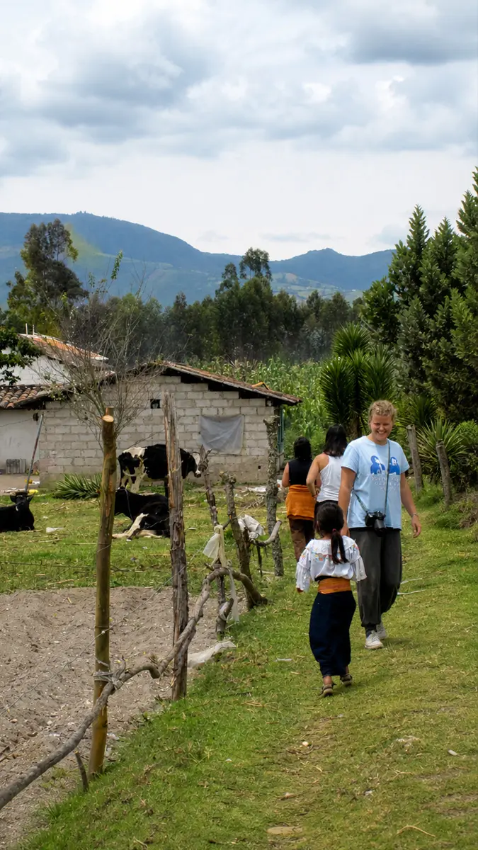 Teen volunteer connecting with an indigenous child during a cultural immersion experience in the Ecuadorian Andes